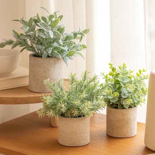 set of 3 small faux potted plants with soft green foliage in minimalist stone-textured pots