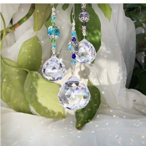 hanging suncatcher crystals​ with indoor plants and sheer curtains in the sunlight