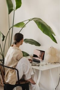 women working in her plant-filled cozy home office