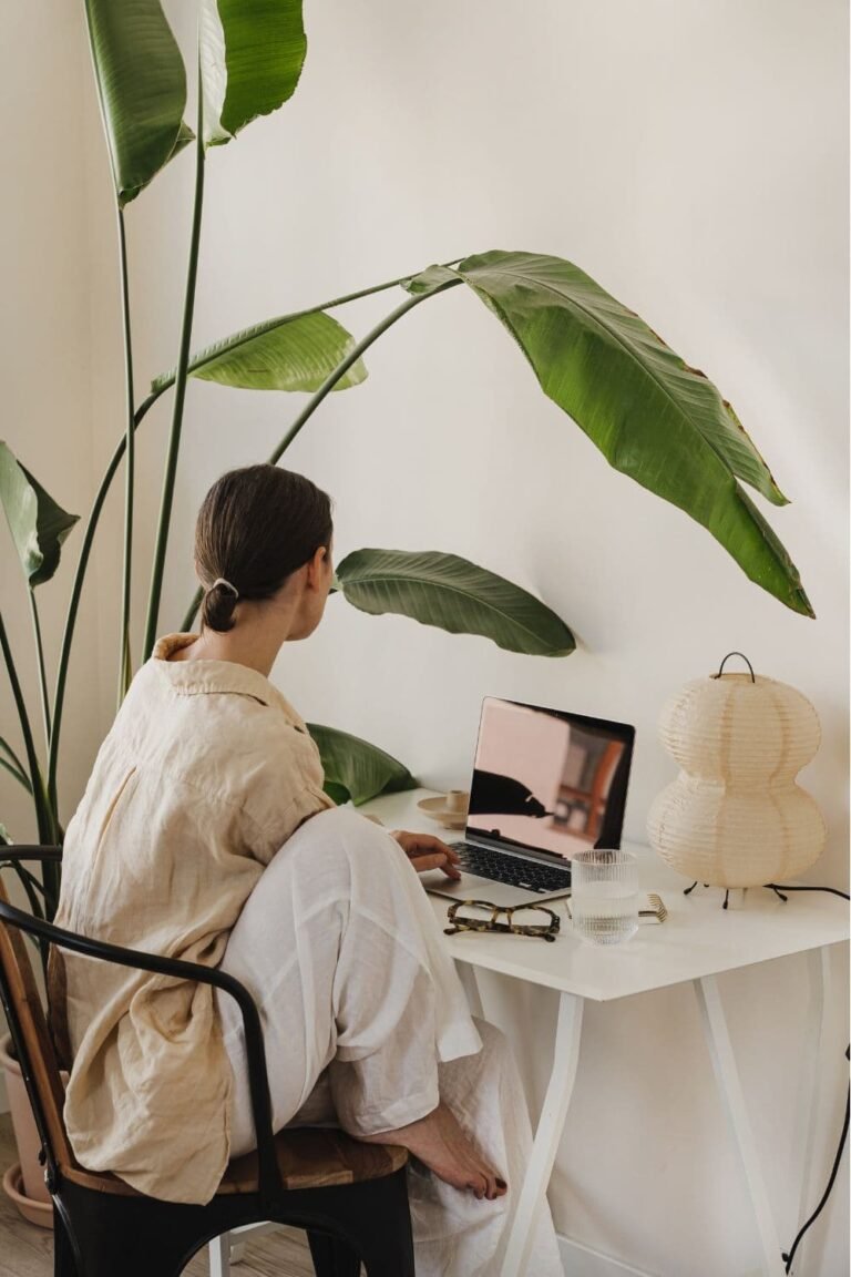 women working in her plant-filled cozy home office