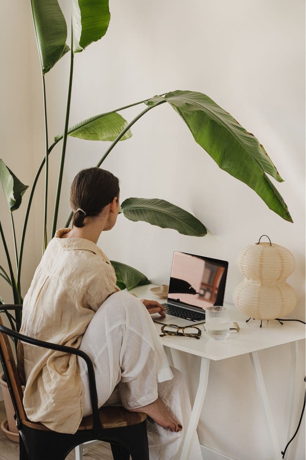 women working in her plant-filled cozy home office
