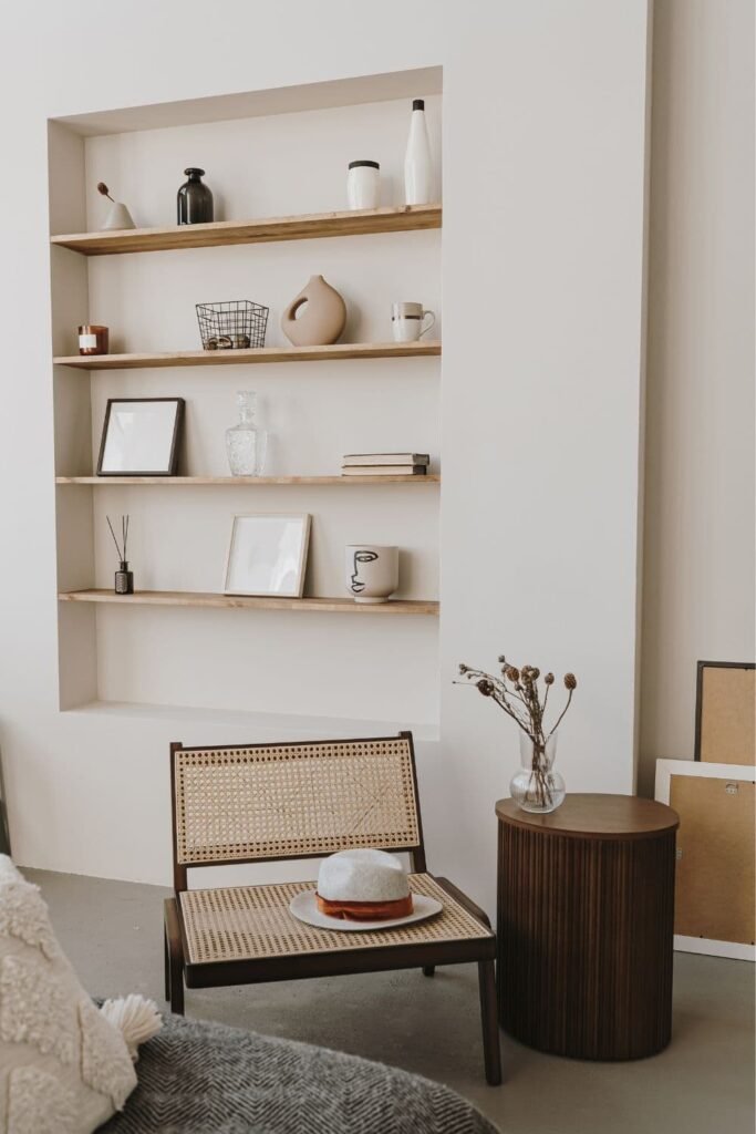 minimalist living room with bookshelves, small coffee table and beige accents 